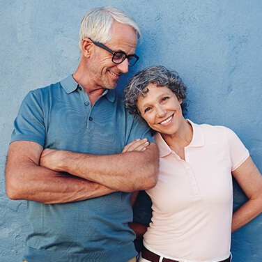 Older couple smiles at camera